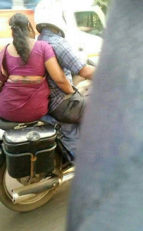 An-Indian-aunty-helping-her-husband-changing-bike-gears-while-driving